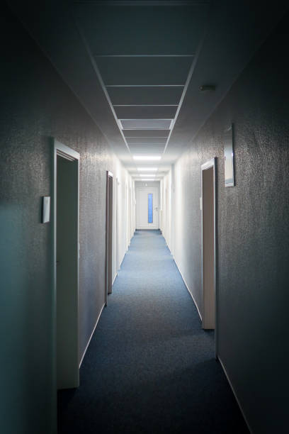 istock long narrow hallway leads to a white door 1372018045