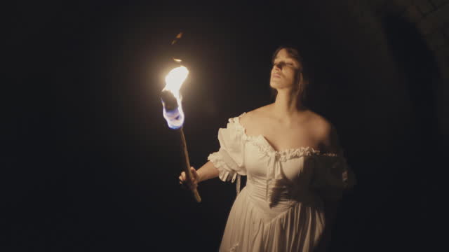 Girl Holding Fire Torch in Medieval Dungeon