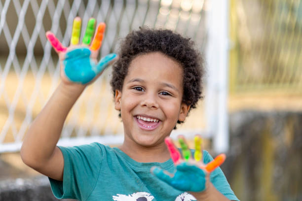 istock beautiful happy boy with painted hands 1372020536