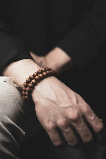 young man posing with bracelets