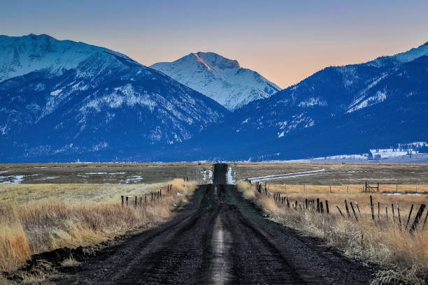 istock Rural road leading to mountains 1372021661