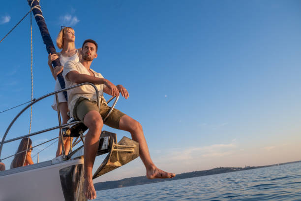istock Couple at sailboat at dusk 1372022428