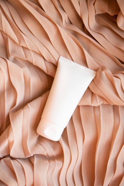 istock White cream tube mock-up on textile background 1372025892
