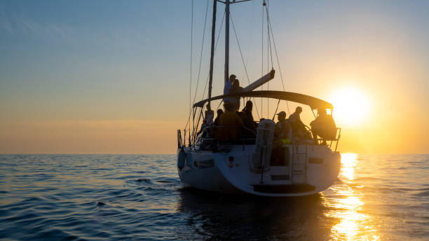 istock Sailboat on romantic cruise on rippled sea against setting sun 1372026062
