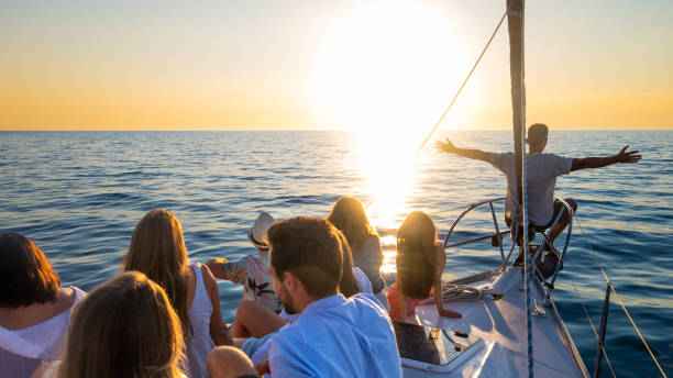 istock People sitting on bow deck and watching romantic sunset over sea 1372026067