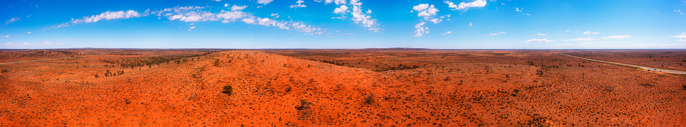 Scenic red soil hill range of Dolo hill rest stop on Barrier highway in outback of Australia - aerial panorama.