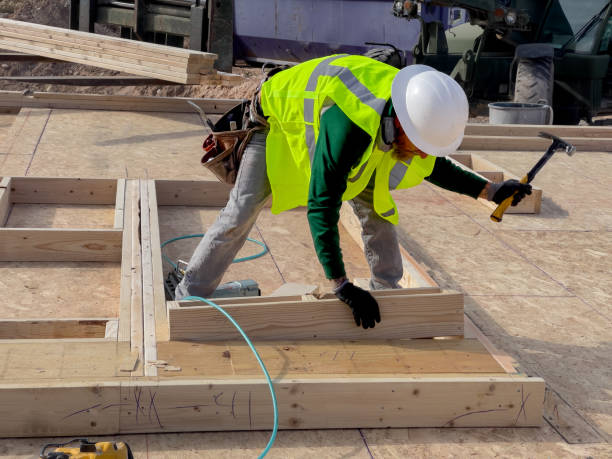 istock Carpenter Framer using a nail gun to attach lumber together while building a new home 1372027094