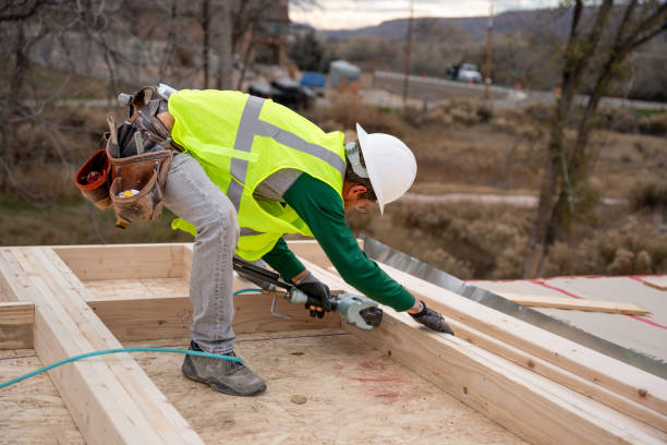 istock Carpenter Framer using a nail gun to attach lumber together while building a new home 1372027327