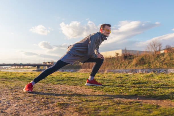 istock Young man wearing running clothes stretching out before his run during sunset 1372028042