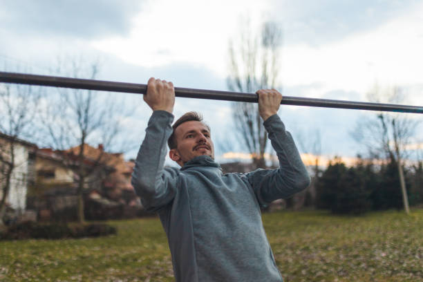 istock Young male athlete pulling himself on a gymnastics bar outdoors 1372029186