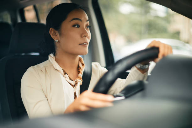istock Young Asian woman driving a car. 1372029485