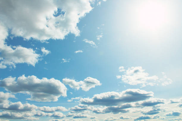 Beautiful cumulus clouds and bright real sun. Background. Landscape.