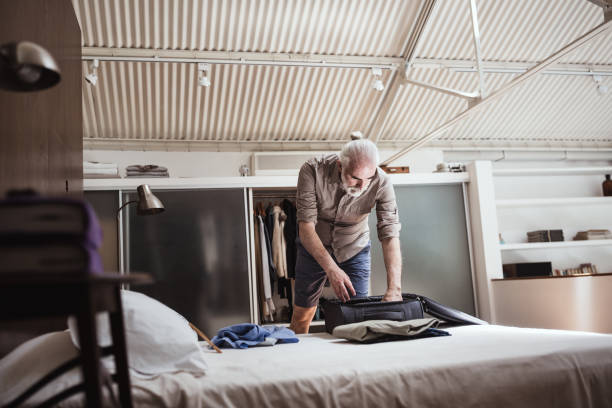 istock Senior man packing for a trip 1372029664