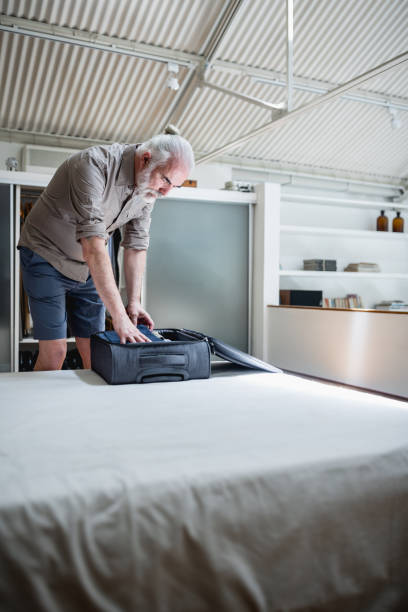 istock Senior man packing for a trip 1372029682
