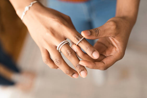 A woman putting a ring on her finger.