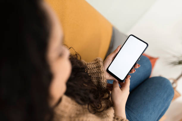 istock Woman relaxing at home and using smartphone 1372030887