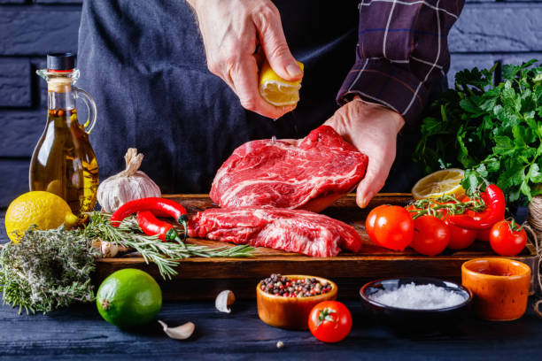 istock chef is sprinkling the lemon juice over beef steak 1372031017