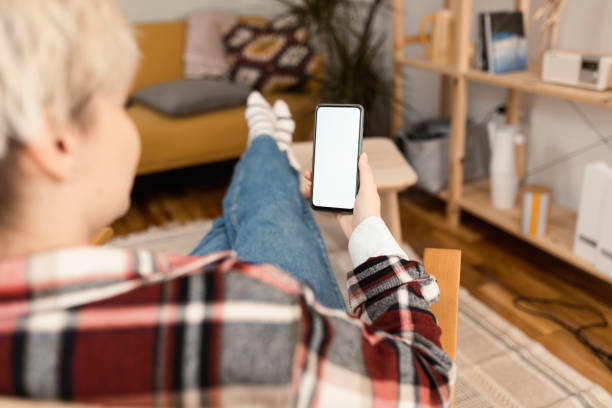 istock Woman using smartphone at home 1372031953
