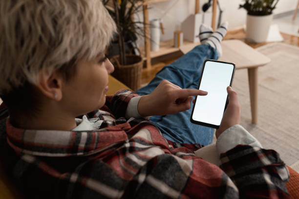 istock Woman using smartphone at home 1372031959