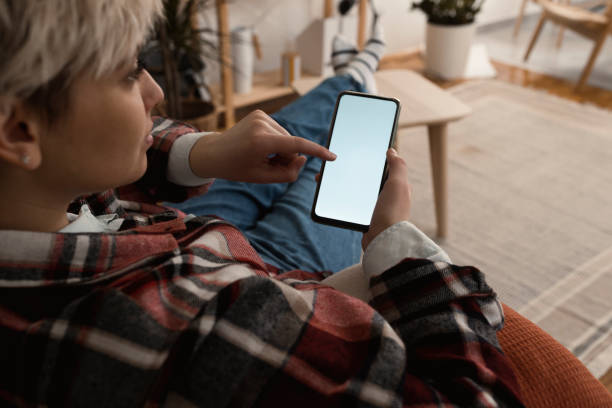 istock Woman relaxing at home and using smartphone 1372031962