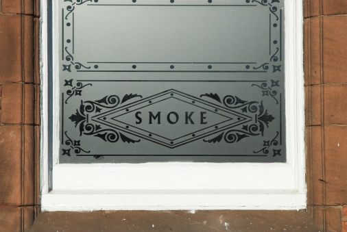 Smoking room window in public house.