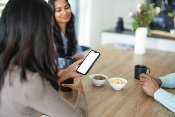 istock Indian Woman Using Smart Phone During Meeting 1372034416