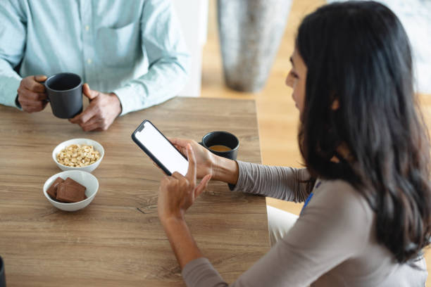 istock Indian Woman Using Smart Phone During Meeting 1372034470