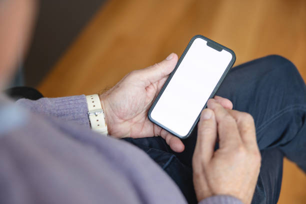 istock Close Up Of A Senior Man Using Smart Phone  At Home 1372035246