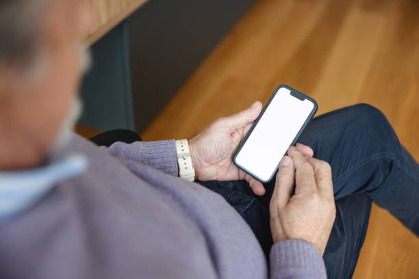 istock Close Up Of A Senior Man Using Smart Phone  At Home 1372035377