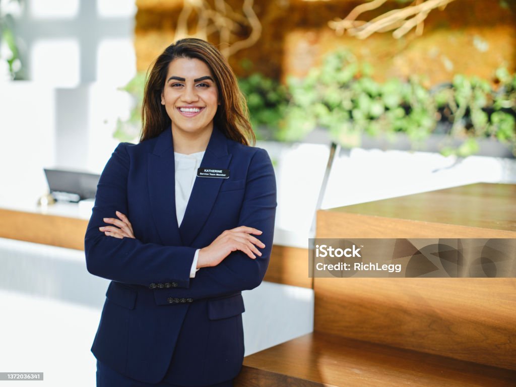 Hotel Employee A hotel employee at the front desk. Hotel Stock Photo