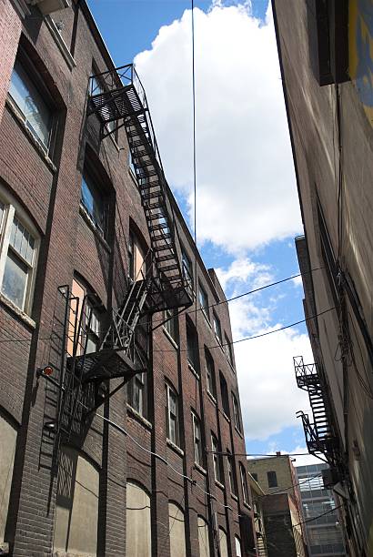 City Alley City alley with fire escape. seedy alley stock pictures, royalty-free photos & images