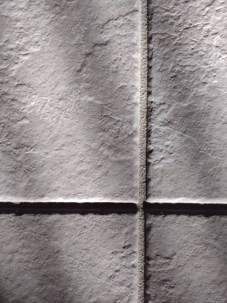Shadow and light interplay on ceramic tile and grout, an image of texture and patterns