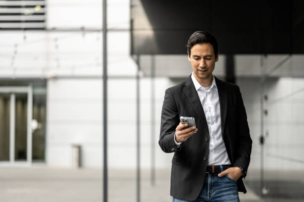 istock Multiracial businessman using a smart phone outdoors 1372040992