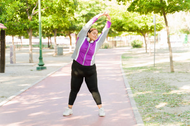 istock Relaxed overweight woman exercising 1372043631