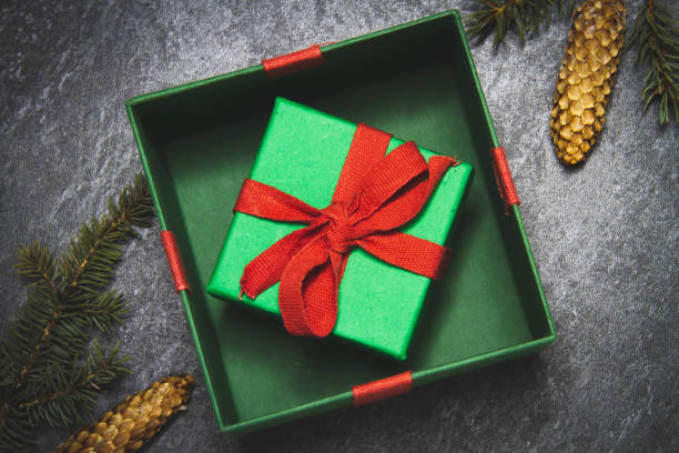 istock Gift box on a black background. New Year's gift top view. Red and green boxes. 1372049648