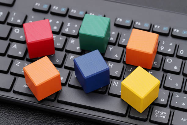 istock wooden toy blocks on computer keyboard 1372053101