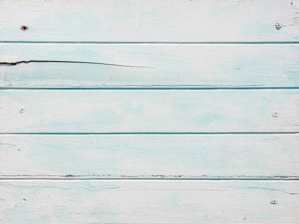 istock Old worn, weathered, pale turquoise and white painted wood paneling background. 1372055791