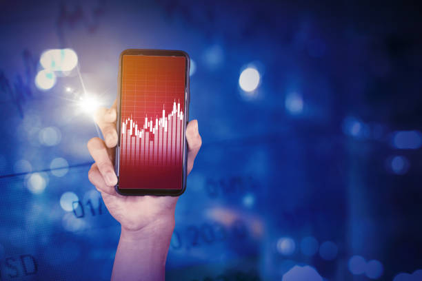 istock Man showing candlesticks chart on the cellphone 1372058140
