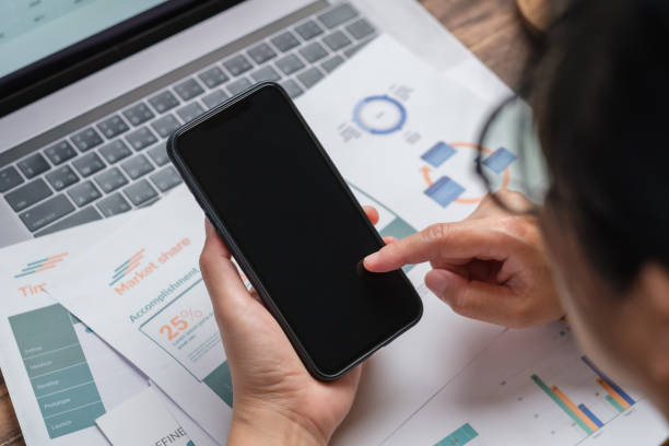 istock close up woman using mobile phone when working at desk at home 1372058158