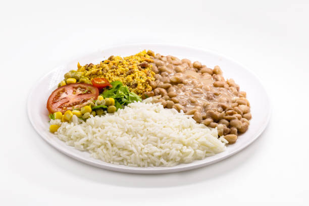 istock rice and beans dish, chopped tomato salad with corn and peas, on isolated white background, traditional brazilian meal 1372058318