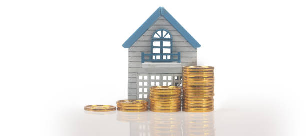 istock Model of detached miniature house mock and coins 1372060720