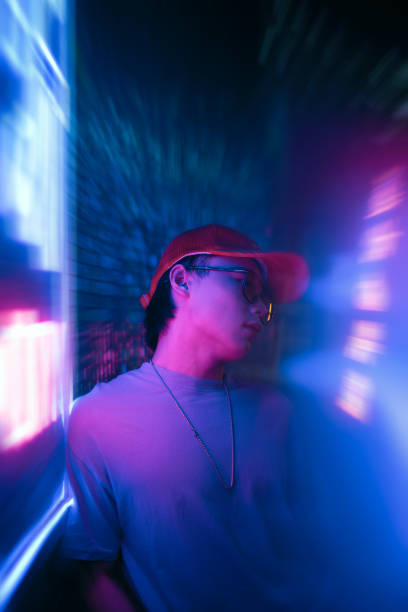 istock Asian male youth under neon lights 1372060802