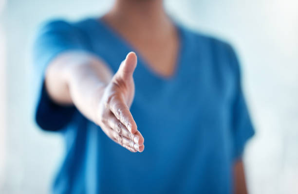 shot of an unrecognisable doctor reaching to shake your hand - reaching human hand handshake support imagens e fotografias de stock