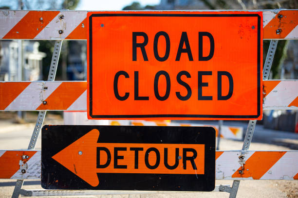 Road closed detour up close Road closed and detour signs w barrier up close finishing stock pictures, royalty-free photos & images