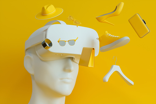 Human Head Model Wearing VR Glasses And Shopping Online. Hat, Shoe, Sunglasses And Clutch Bag Flying On Yellow Background.