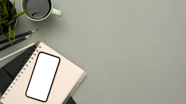 istock Modern grey workspace background with copy space and smartphone mockup 1372063408