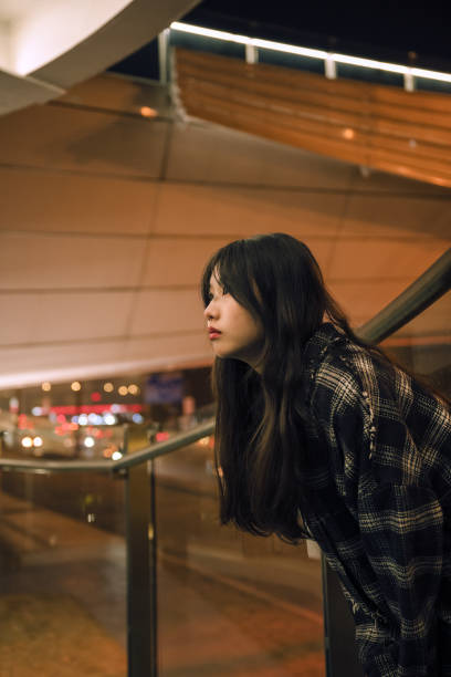 istock Asian girls on the bridge at night 1372063992