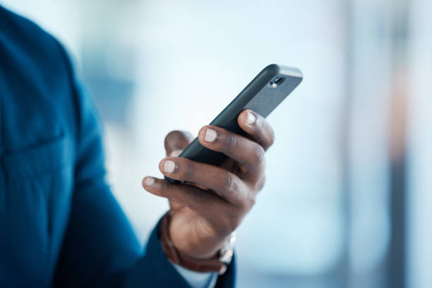 istock Shot of an unrecognisable businessman using a smartphone in a modern office 1372065911