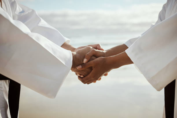 istock Closeup shot of two unrecognizable martial artists practicing karate on the beach 1372066842