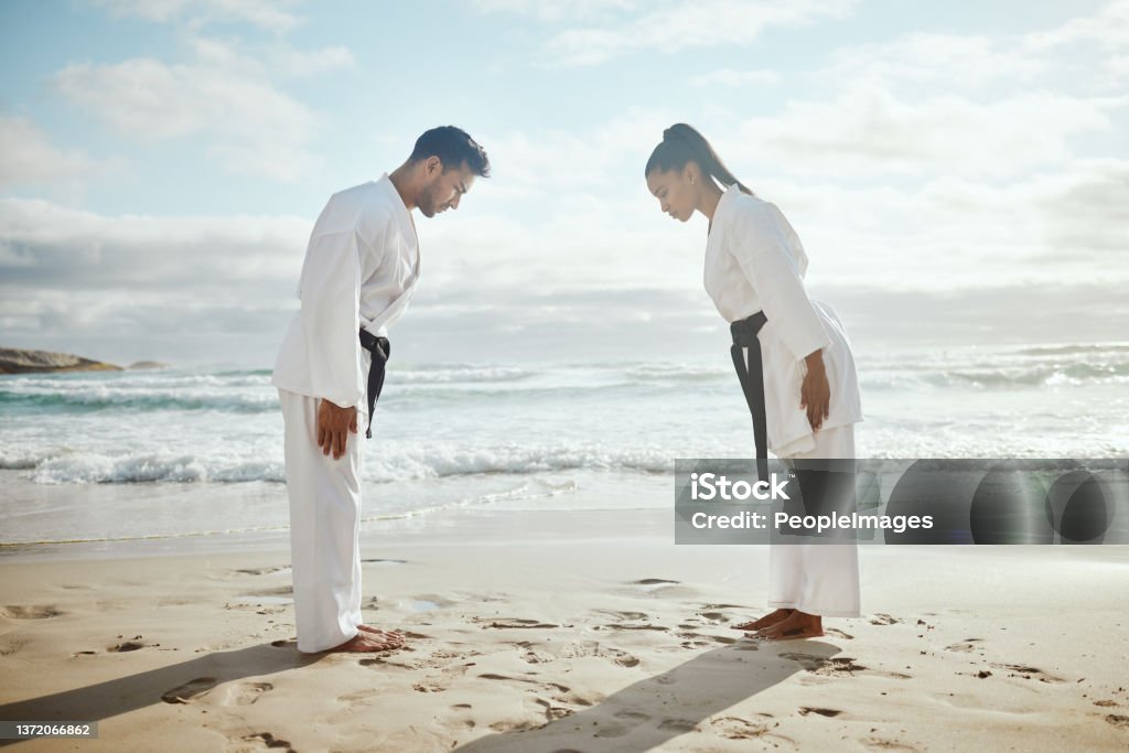 Full length shot of two young martial artists practicing karate on the beach First we bow, then we fight Judo Stock Photo